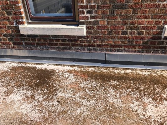 Image depicts a before image from a roof replacement project in Lambton County