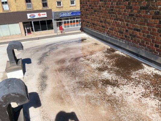 Image depicts a before image from a roof replacement project in Lambton County