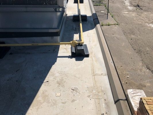 Image depicts a before image from a roof replacement project in Lambton County