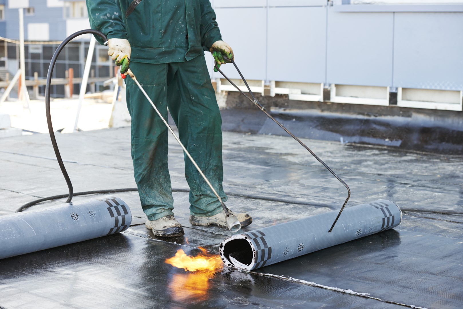 Image depicts a roofer installing a roof.