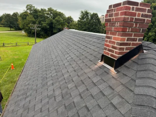 heritage building shingle replacement company black shingles with red chimney