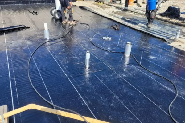 installing first layer of roofing membrane